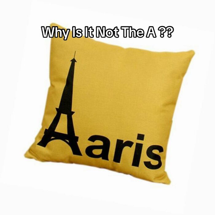 Hilariously bad design fail on a yellow pillow, showing an Eiffel Tower as the A in Aaris instead of Paris.