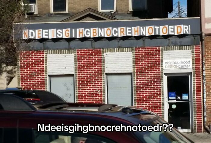 A building with the sign 'NDEESIGIHGBNOCREHNOTOEDR', a jumbled mess and a hilariously bad design fail.