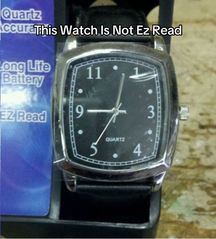 A close-up of a wrist watch with numbers 1, 3, 4, 5, 9, 11 visible, showing a bad design fail making it hard to read.