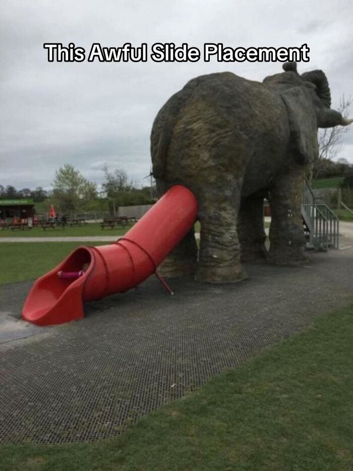 A hilariously bad design fail: a children's slide emerging from the rear of a large elephant statue.