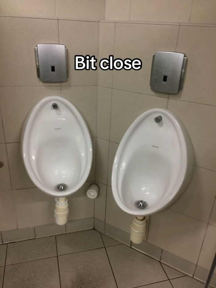 A hilariously bad design fail: two urinals placed extremely close together in a public restroom.