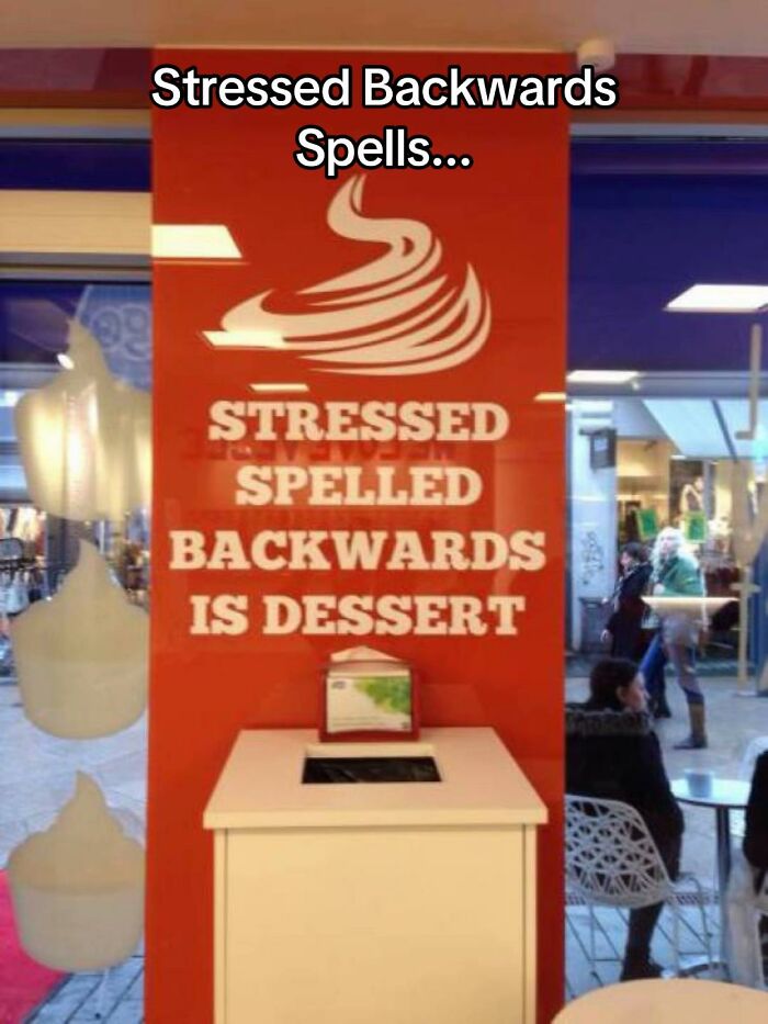 A red sign in a dessert shop window with text about STRESSED spelled backwards, a bad design fail example.