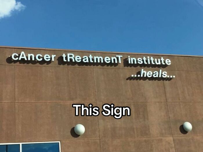 A hilariously bad design fail: a poorly formatted sign for a 'cAncer tReatmenT institute ...heals...'