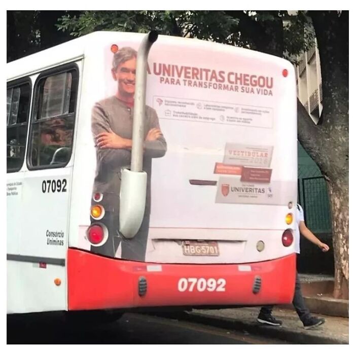 Bus with ill-placed exhaust pipe overlapping a person's image creating design fail