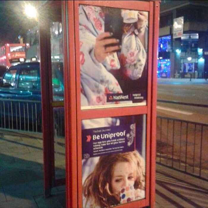 Outdoor advertisement pole with posters obstructing phone access