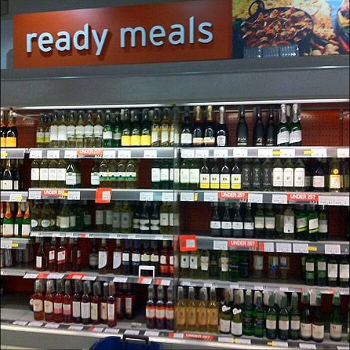 Wine bottles placed under a sign reading ready meals, illustrating a design fail