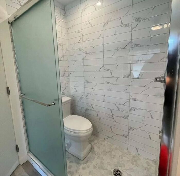 Bathroom shower area with toilet inside the shower space design fail
