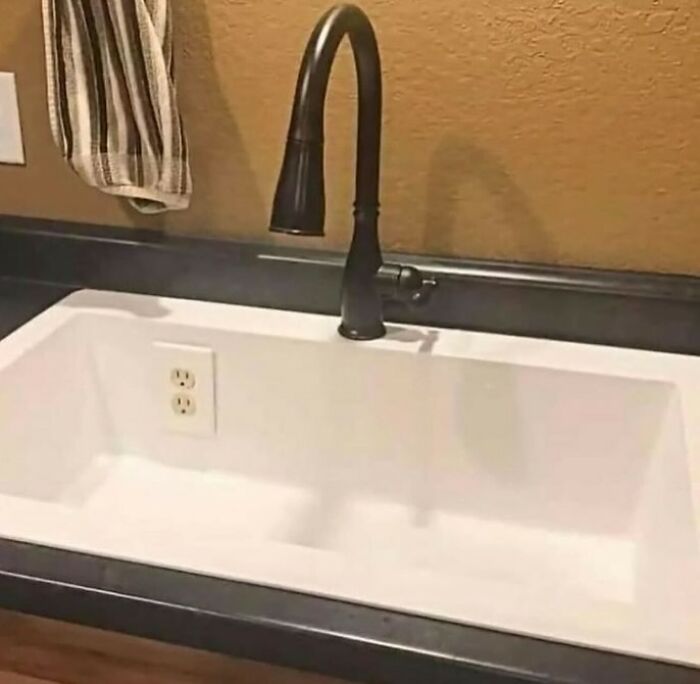 Kitchen sink with a power outlet installed inside the basin