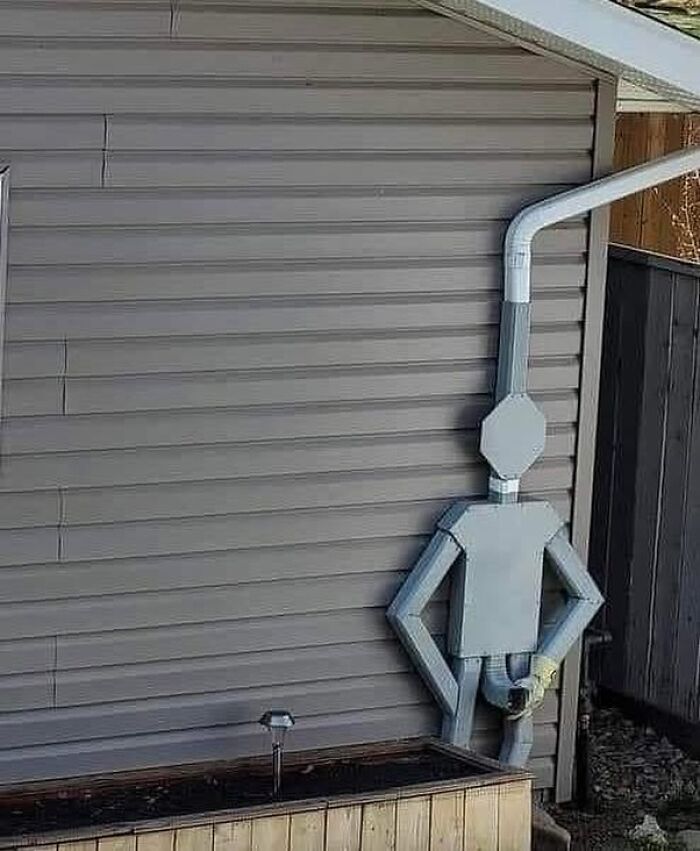 Downspout creatively designed to look like a person washing hands