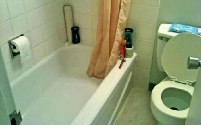Poor bathroom layout with bathtub obstructed by toilet