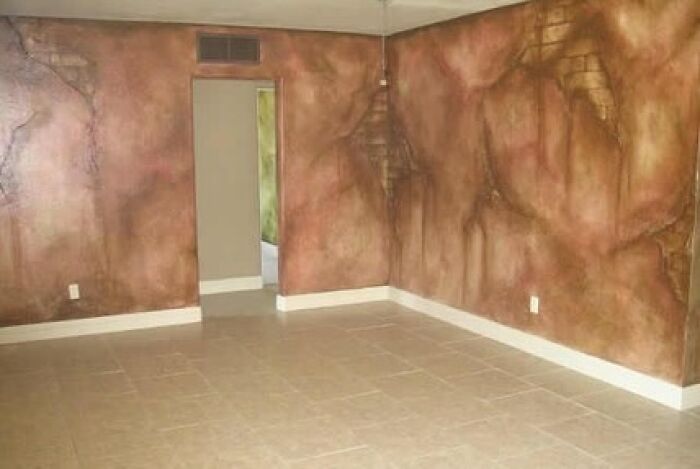 Room with wall painted to look like cracked stone causing a design fail