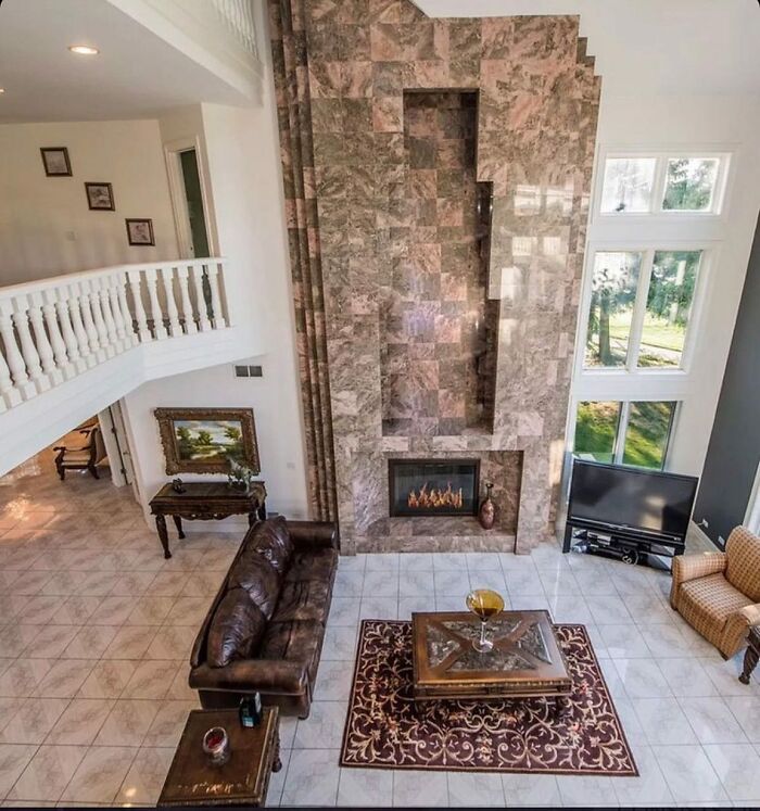 Living room with an oddly designed stone fireplace that looks out of place