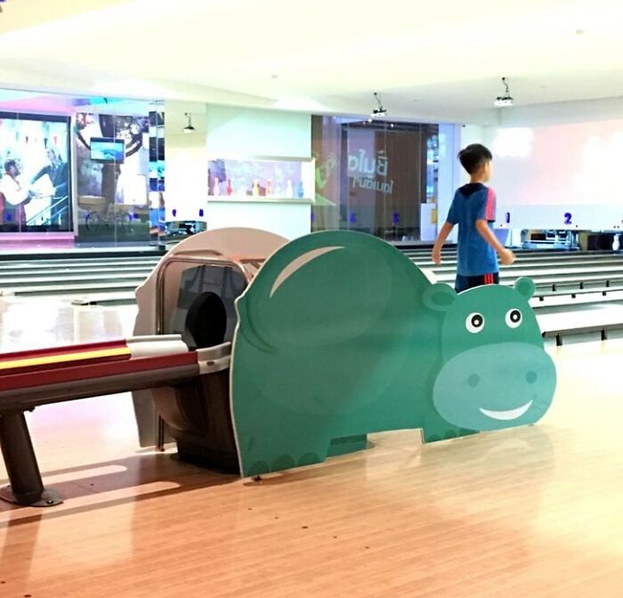 Cringeworthy design fail of bathtub disguised as a hippo at a bowling alley