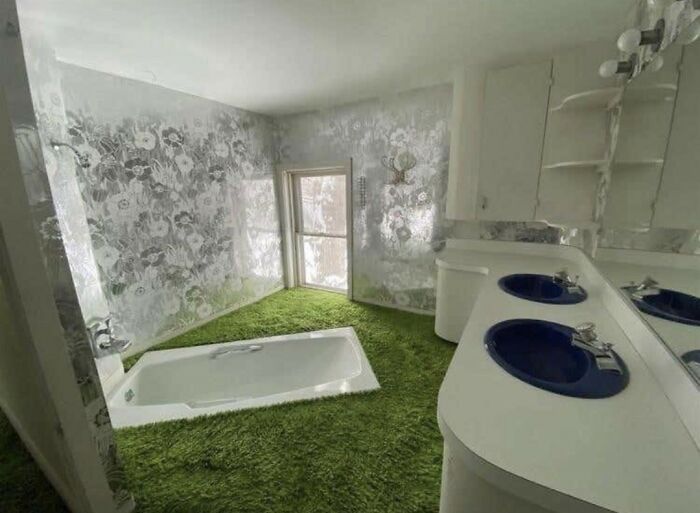 Bathroom design fail with bathtub surrounded by green carpet flooring