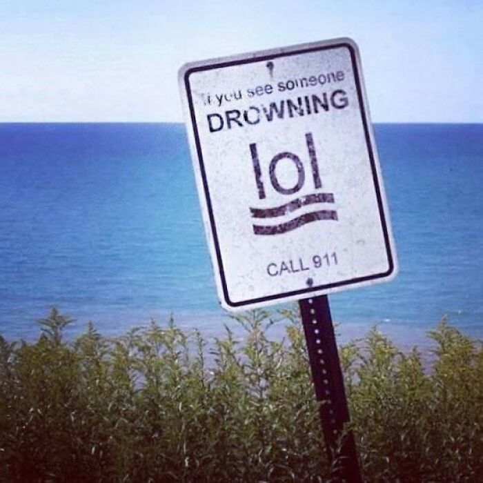 Funny drowning warning sign with lol text by the water