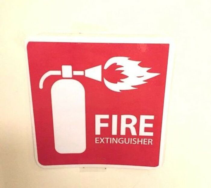Funny fire extinguisher sign showing fire coming out of extinguisher nozzle