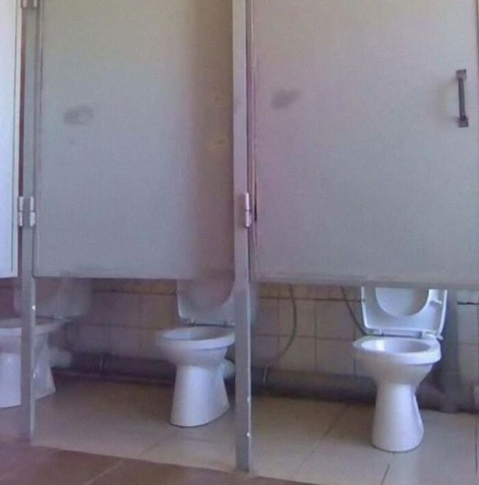 Public restroom with design fail having toilet stalls without doors for privacy