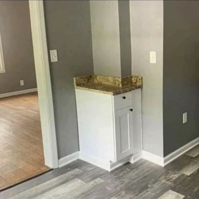 Cringeworthy design fail of countertop and cabinet that don't fit wall corner