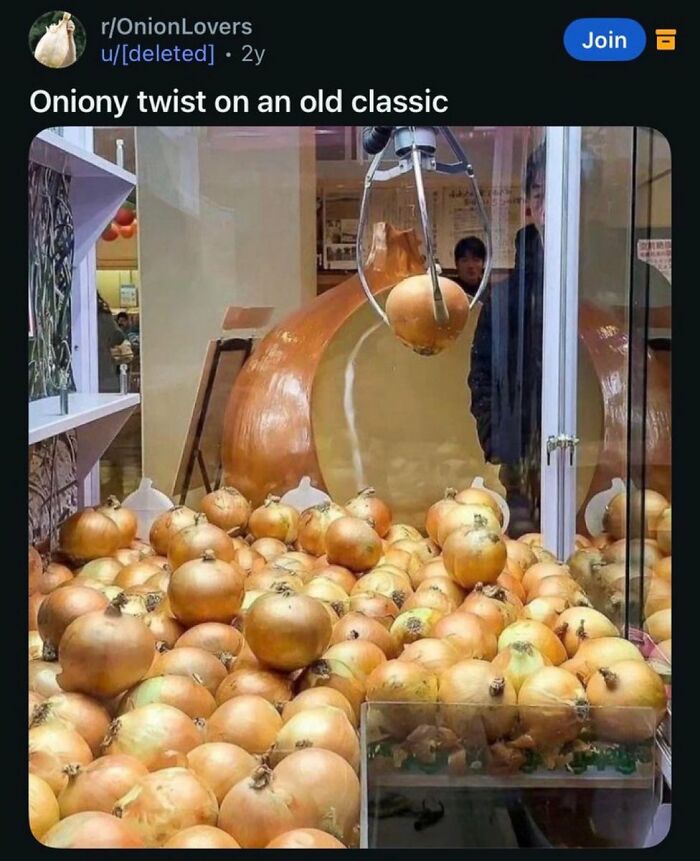 A claw machine filled with onions, a giant onion backdrop. A funny post about broken humor.