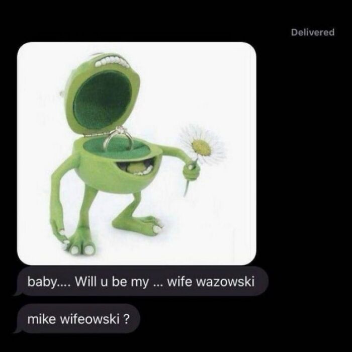 A Mike Wazowski engagement ring box holding a ring and a flower. A savage comment proposing to wife Wazowski.