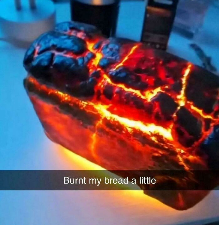 Extremely burnt bread loaf glowing like lava heat