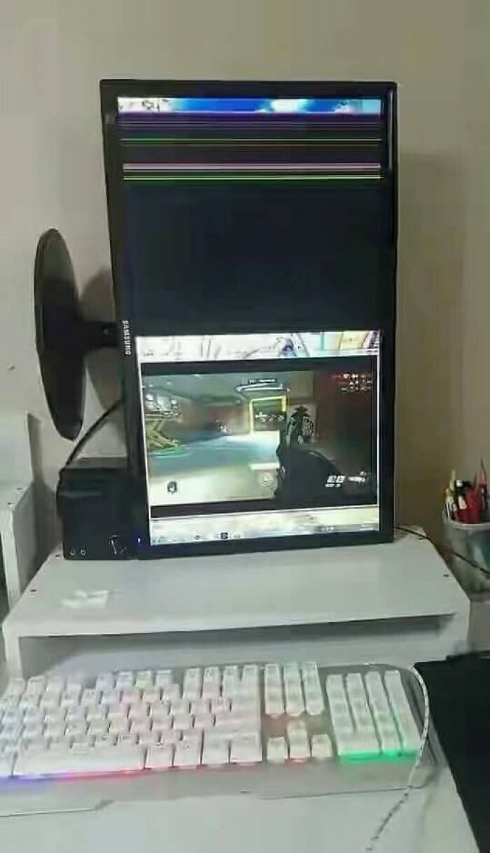 A vertical computer monitor displaying a broken top half and a game in the bottom, an example of Slavic Science.