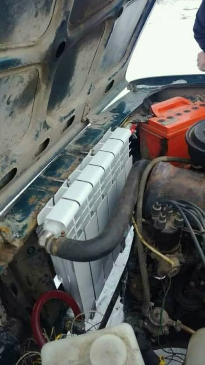 A home radiator installed as a car's engine cooler, an example of unusual Slavic science and repair.