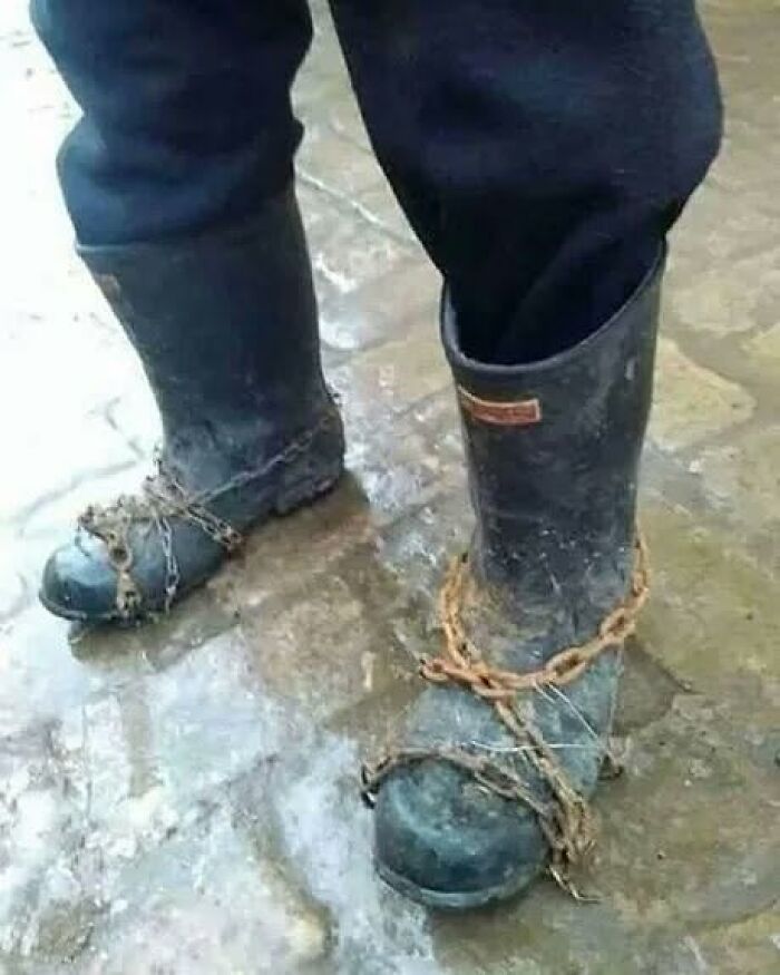 Someone wearing rubber boots with chains wrapped around them for traction, highlighting Slavic science.