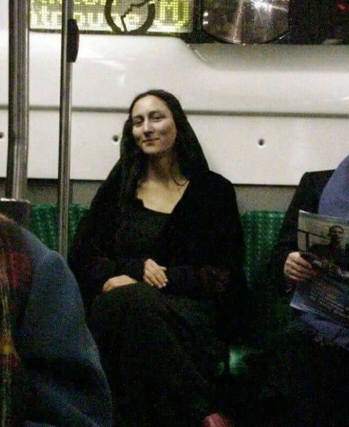 A woman resembling the Mona Lisa smiles while riding public transportation, one of the great photos that became Internet legends.