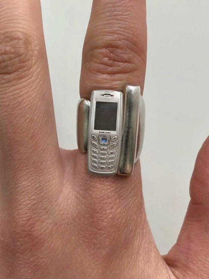 A hand wearing a ring with a tiny mobile phone attached, one of the great photos from the Internet.