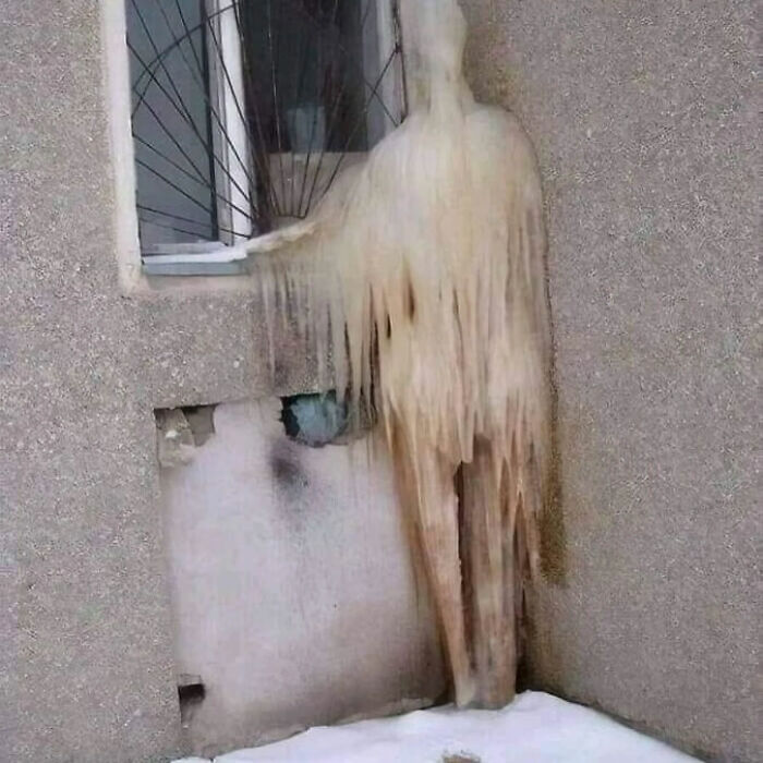 A figure made of ice clinging to a window in a photo that became a legend of the internet.