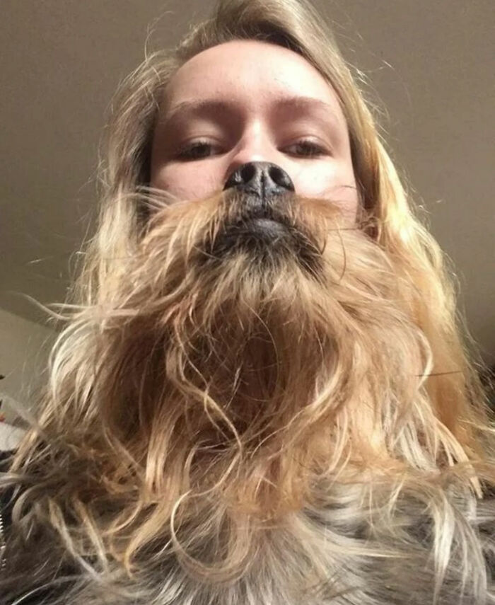 A woman holding a dog upside down to create the illusion of a beard, a great photo and legend of the Internet.