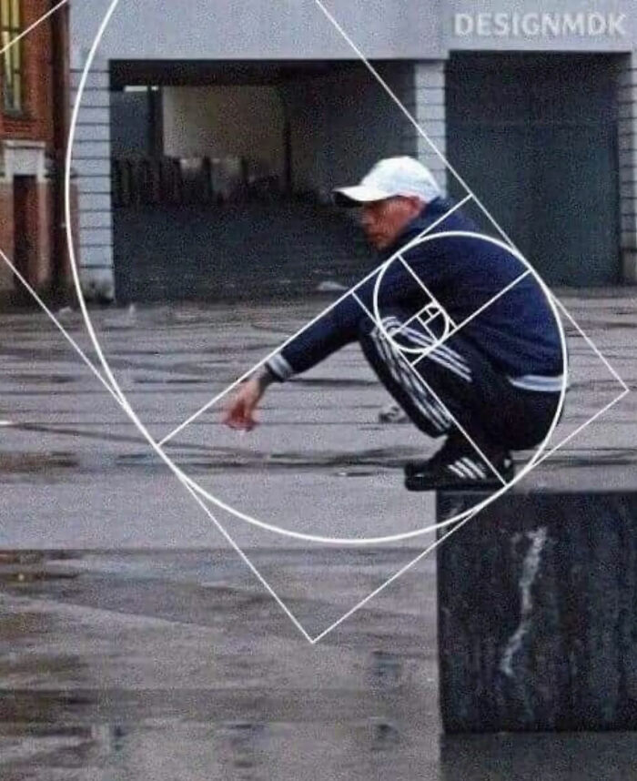 A man squatting on a block with a golden ratio overlay, one of the internet's great photos.