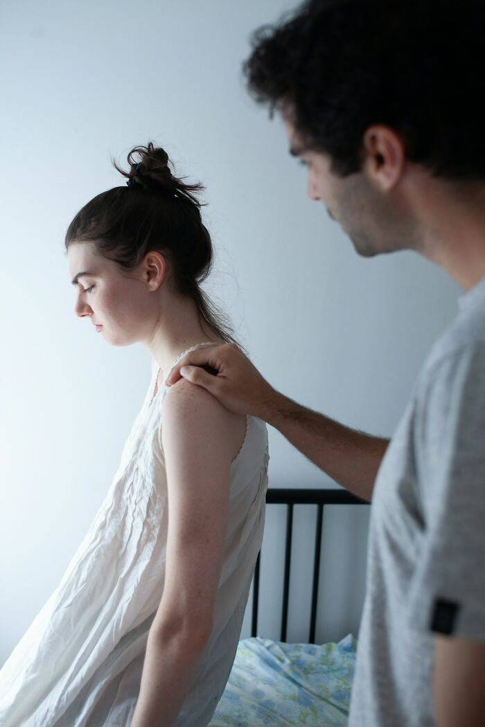 Man comforting upset woman after discovering infidelity