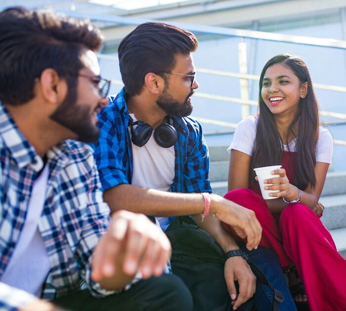 Group of friends happily chatting and socializing outdoors