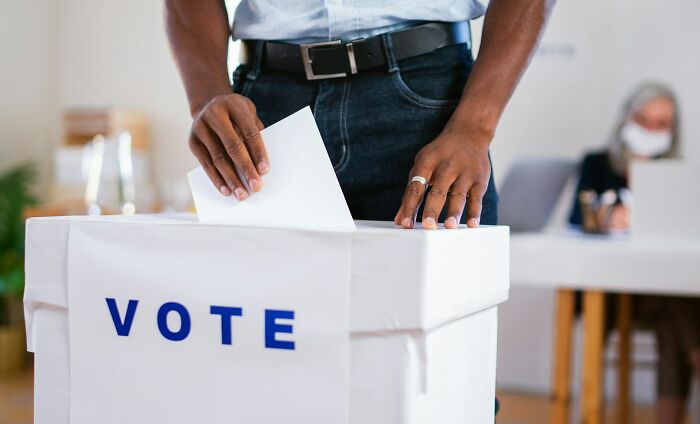 A person casting a vote, symbolizing things people found regarding their partners.