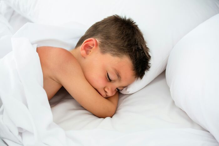 A child sleeping peacefully, contrasting the stress teachers feel from entitled parents' messages.