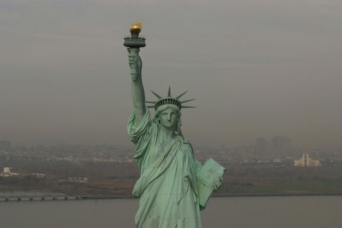 The Statue of Liberty holding her torch and tablet, a famous landmark with interesting useless facts.