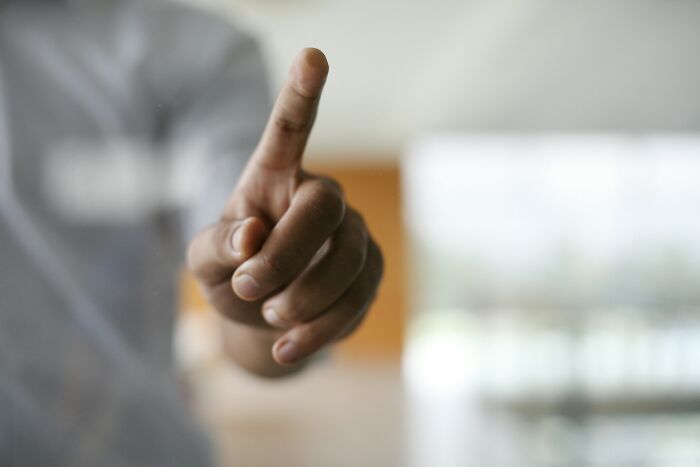A person points their finger forward, demonstrating a silly solution.