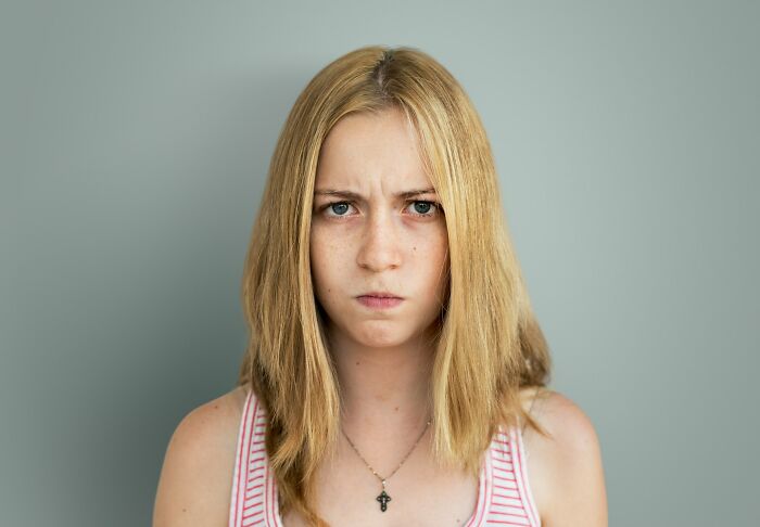 Angry young woman with serious expression about class clown consequences