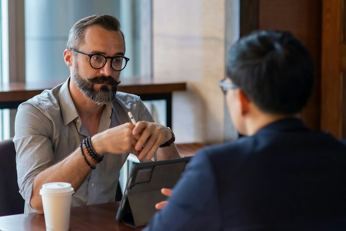Business meeting with two men discussing mass walkouts
