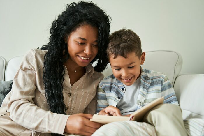 Adult and child reading a book together illustrating Gen Alpha literacy skills