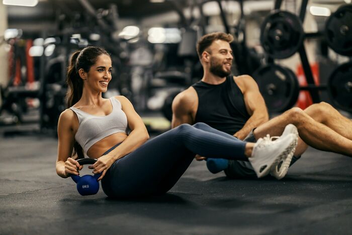 Two people exercising in gym focusing on core workout strength