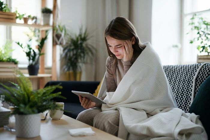 Upset woman discovering shocking messages on tablet from partner's phone