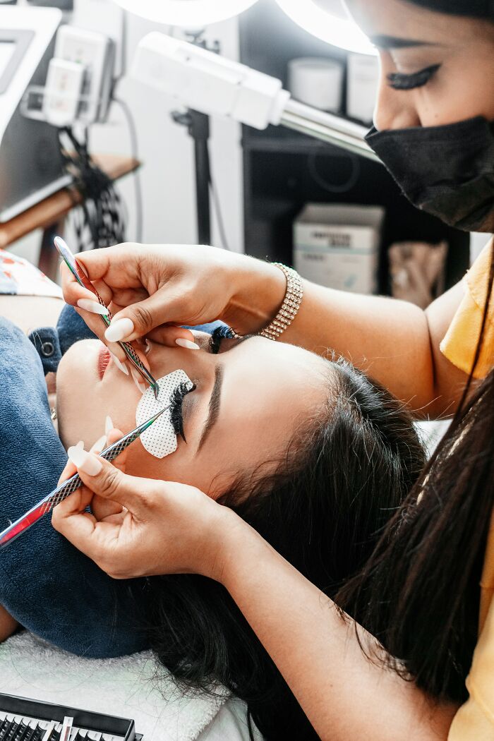 A woman gets eyelash extensions, a beauty enhancement that some men might consider a turn off.
