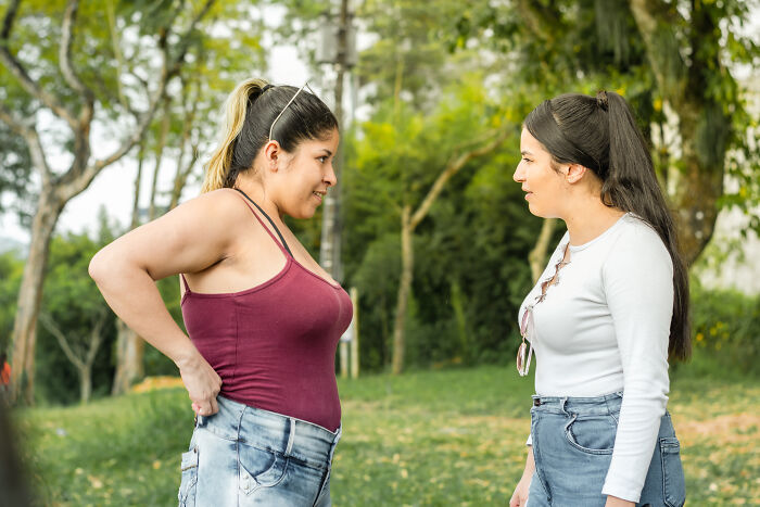 Two women having intense conversation outdoors