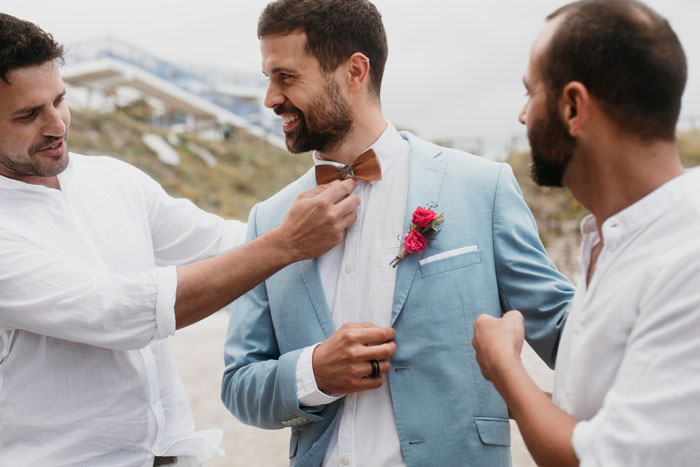 A groom and his best man preparing for the wedding, perhaps before the cheating revelation.