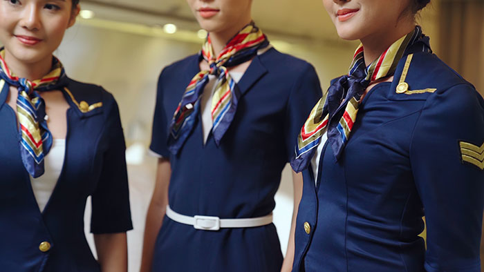 Flight attendants in uniform with colorful scarves Flight attendants in uniform with colorful scarves