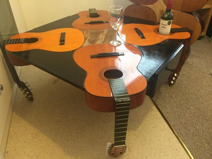 Unique coffee table made from multiple guitars, merging musical design with furniture