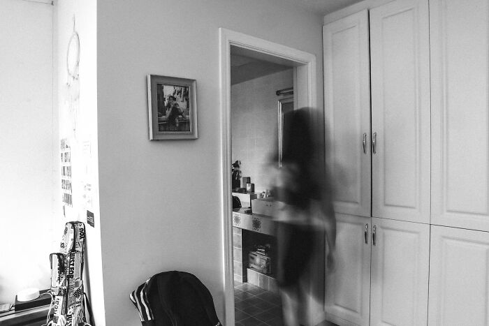 A blurry figure in a doorway, suggesting a creepy, unbelievable encounter.